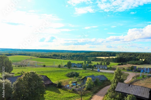 View of the Russian village green fields of the taiga