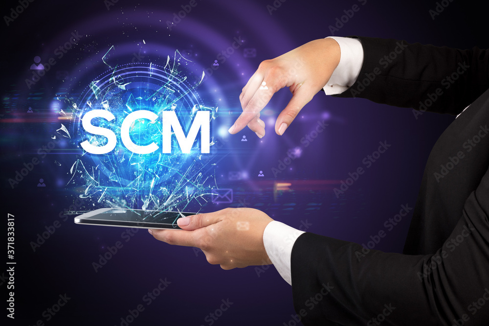 Close-up of a touchscreen with SCM abbreviation, modern technology concept Close-up of a touchscreen with SCM abbreviation, modern technology concept