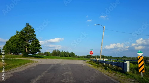 Driving Turning Around Road Bend Corner Approaching Rural Stop Sign, Stopping, and Turning Right. Driver Point of View POV Driver Approach Road Sign and Turns.
