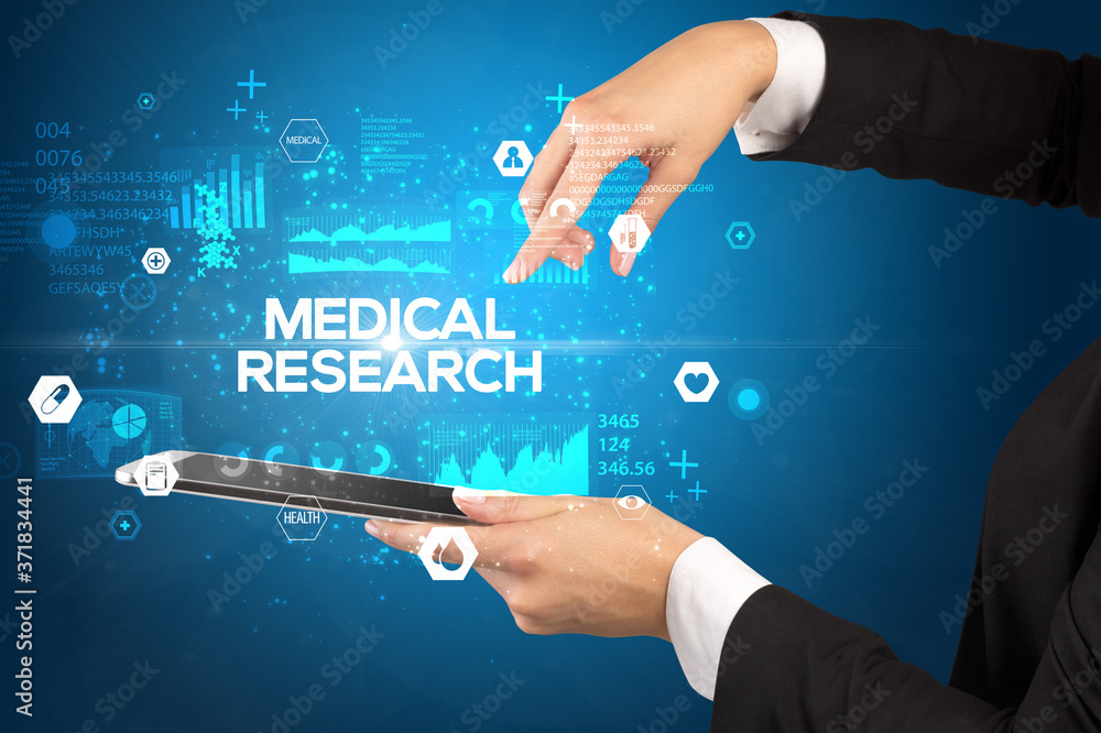 Close-up of a touchscreen with MEDICAL RESEARCH inscription, medical concept Close-up of a touchscreen with MEDICAL RESEARCH inscription, medical concept