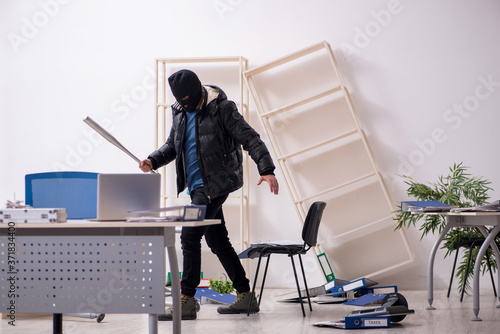 Obraz na plátně Young male burglar in the office