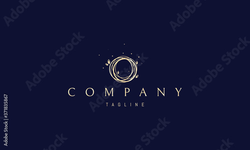 Vector golden logo on which the abstract image of a bird's nest is twisted from thin twigs with a leaf.