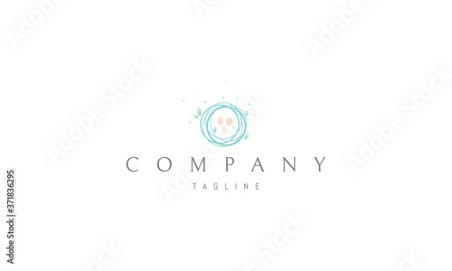 Vector logo on which an abstract image of a nest with eggs top view.