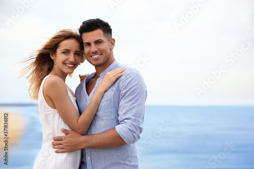 Happy couple on beach, space for text. Romantic walk