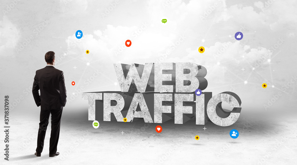 Young businessman standing in front of WEB TRAFFIC inscription, social media concept Young businessman standing in front of WEB TRAFFIC inscription, social media concept