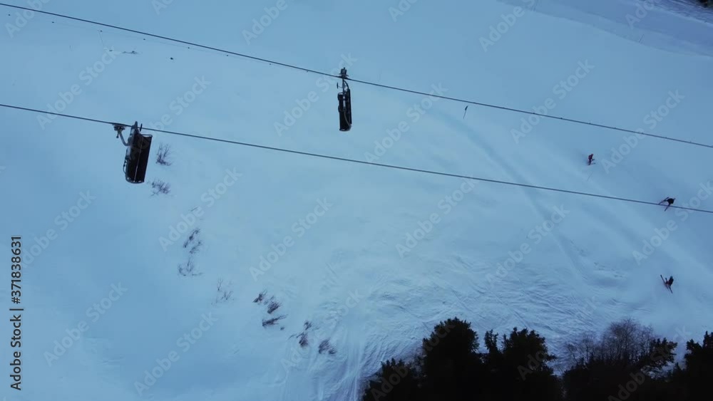 Aerial winter scene of alpine snowy mountain peaks and dark spruce forest in snow Aerial winter scene of alpine snowy mountain peaks and dark spruce forest in snow