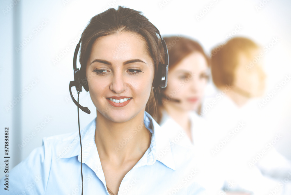 Call center. Focus on beautiful business woman in headset Call center. Focus on beautiful business woman in headset