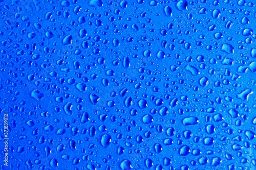 abstract image of a water droplet on a blue background. concept of water droplet structure for a postcard or banner background