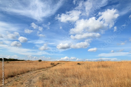 Dirt road in the field and clouds in the vicinity of the village of Avren (Bulgaria)