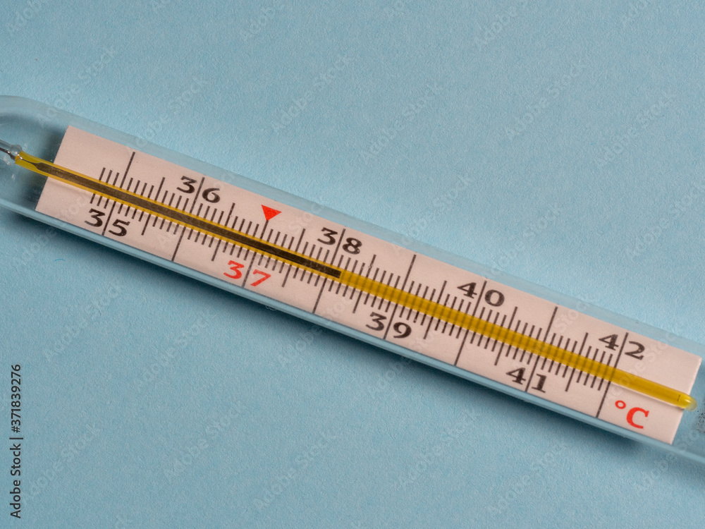 mercury thermometer on a blue background, top view. Tool for changing the temperature of patients mercury thermometer on a blue background, top view. Tool for changing the temperature of patients