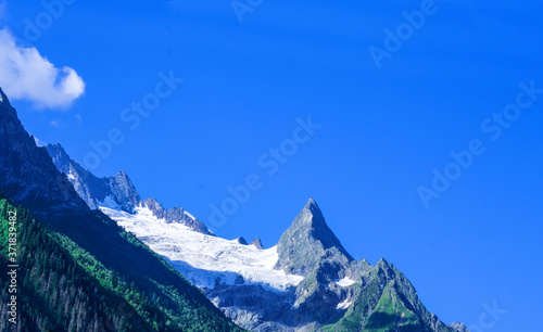 Beautiful landscape of mountain peaks with snow and forest