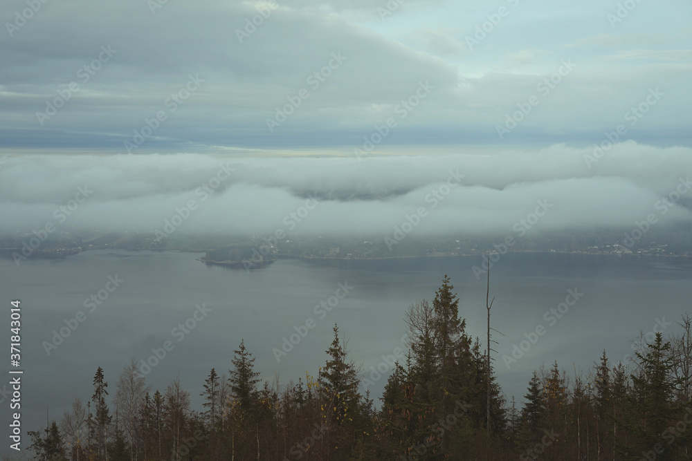 Fototapeta premium Drammens fjord covered with fog at evening.
