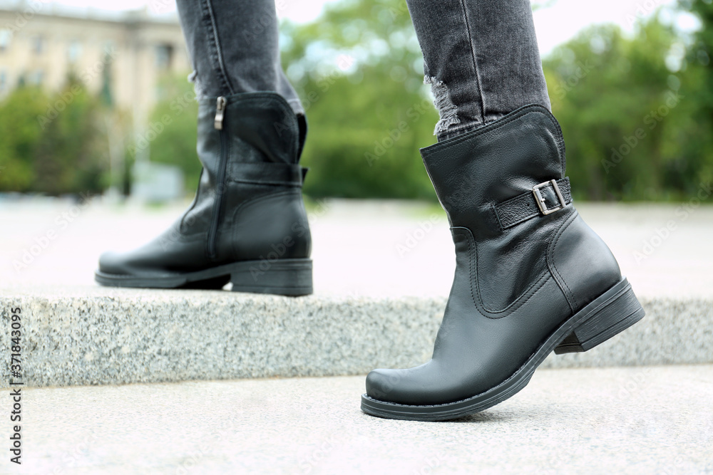 Woman wearing comfortable stylish boots outdoors, closeup