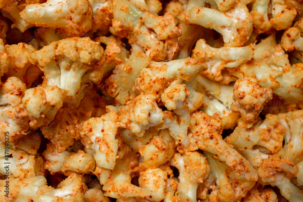 Cauliflower florets cut, spiced and ready to be fried or baked Cauliflower florets cut, spiced and ready to be fried or baked