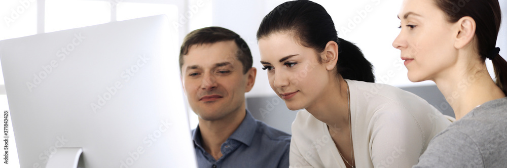 Group of business people discussing questions at meeting in modern office. Headshot at negotiation or workplace. Teamwork, partnership and business concept Group of business people discussing questions at meeting in modern office. Headshot at negotiation or workplace. Teamwork, partnership and business concept