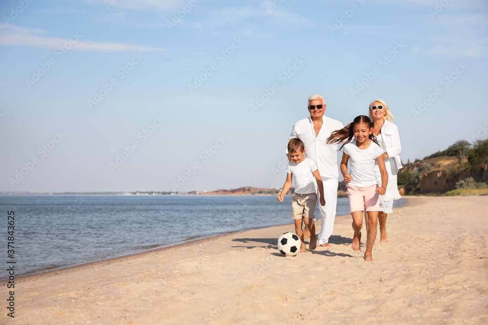 Cute little children with grandparents spending time together on sea beach