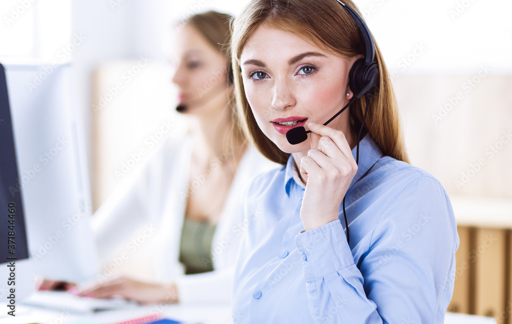 Portrait of call center operator at work. Group of people in a headset ready to help customers. Business concept Portrait of call center operator at work. Group of people in a headset ready to help customers. Business concept