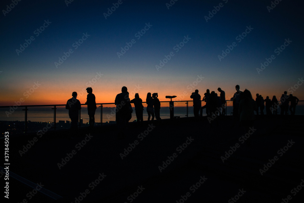 silhouette of people at sunset