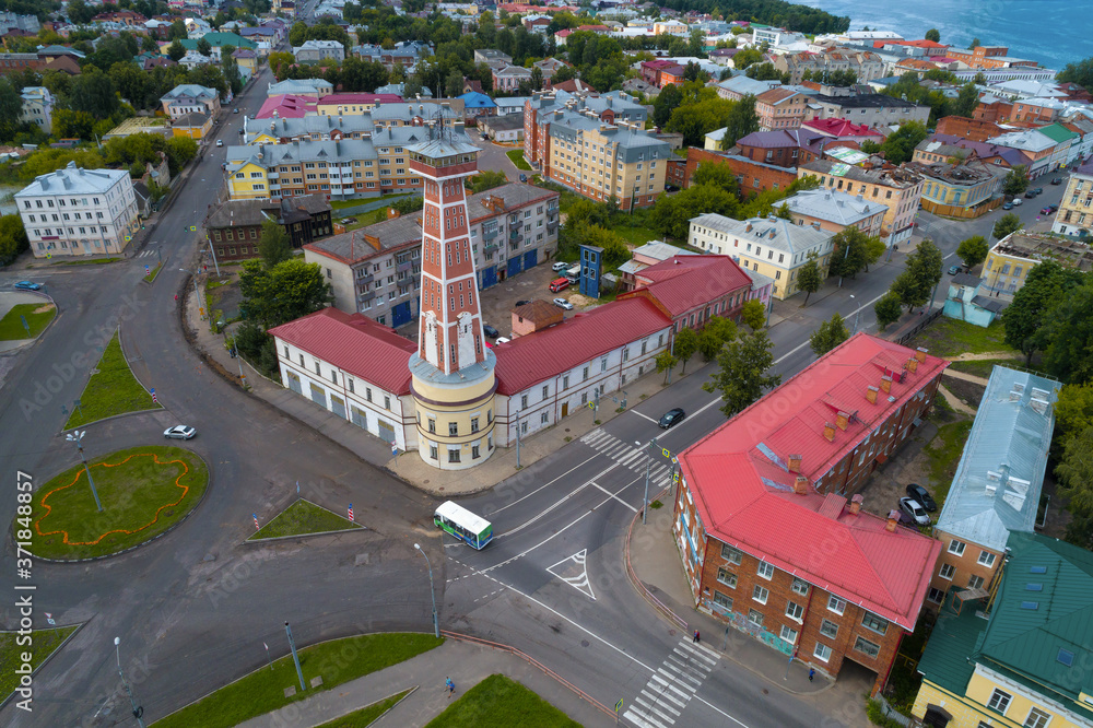 An old fire tower in the urban landscape of Rybinsk on a sunny July morning (aerial photography). Yaroslavl region, Russia