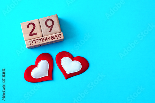 World heart day, health and medical concept. Two hearts and an inscription on wooden cubes September 29