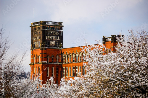 Belper East Mill in winter, through the trees photo