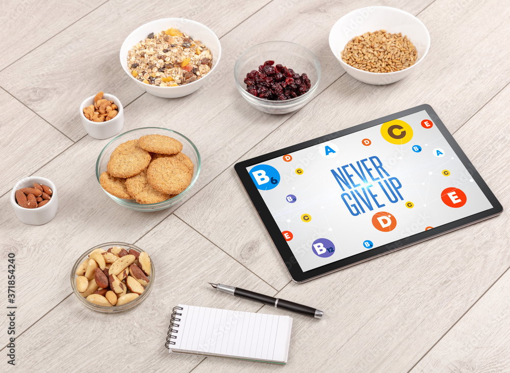 Healthy Tablet Pc compostion with NEVER GIVE UP inscription, weight loss concept Healthy Tablet Pc compostion with NEVER GIVE UP inscription, weight loss concept