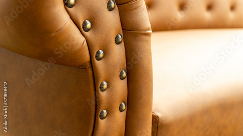 Close up of pins and buttons on a vintage style sofa. Buttoned vintage sofa up close.
