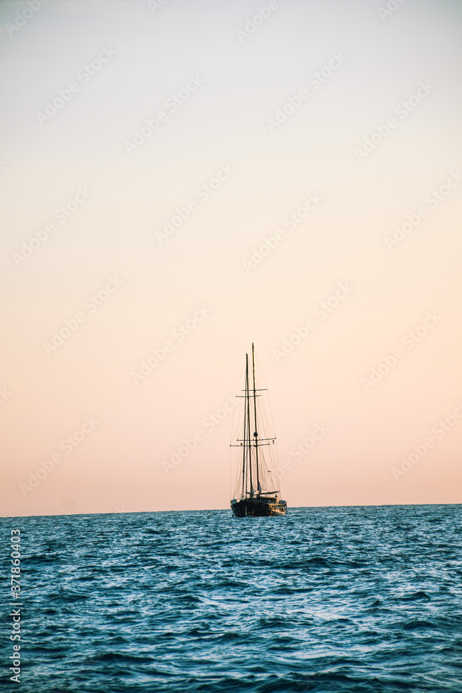Sailing boat sailing during sunset