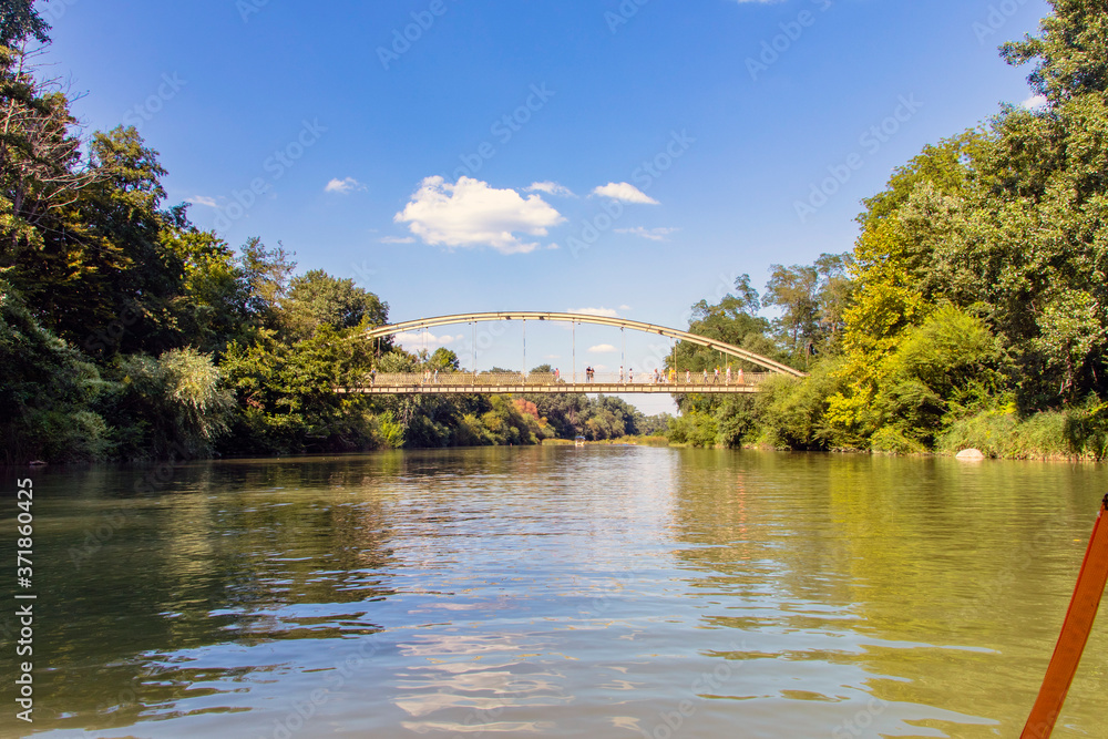 Fototapeta premium The river flows through the resort town of Goryachy Klyuch. Bridge over a mountain river.