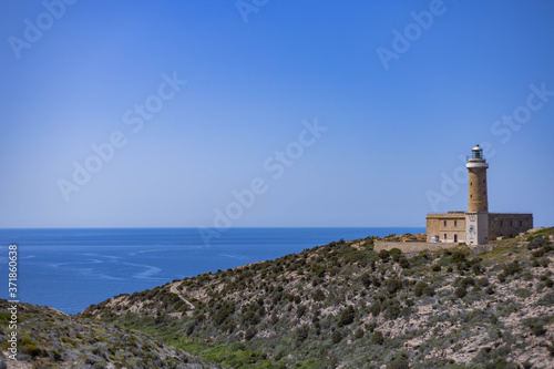 View of Mediterranean Sea with lighthouse from Belvedere di Capo Sandalo, Carloforte, Sardinia, Italy
