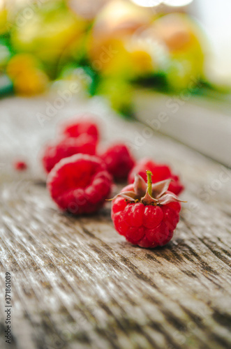 Raspberries on a wooden bench in the village
