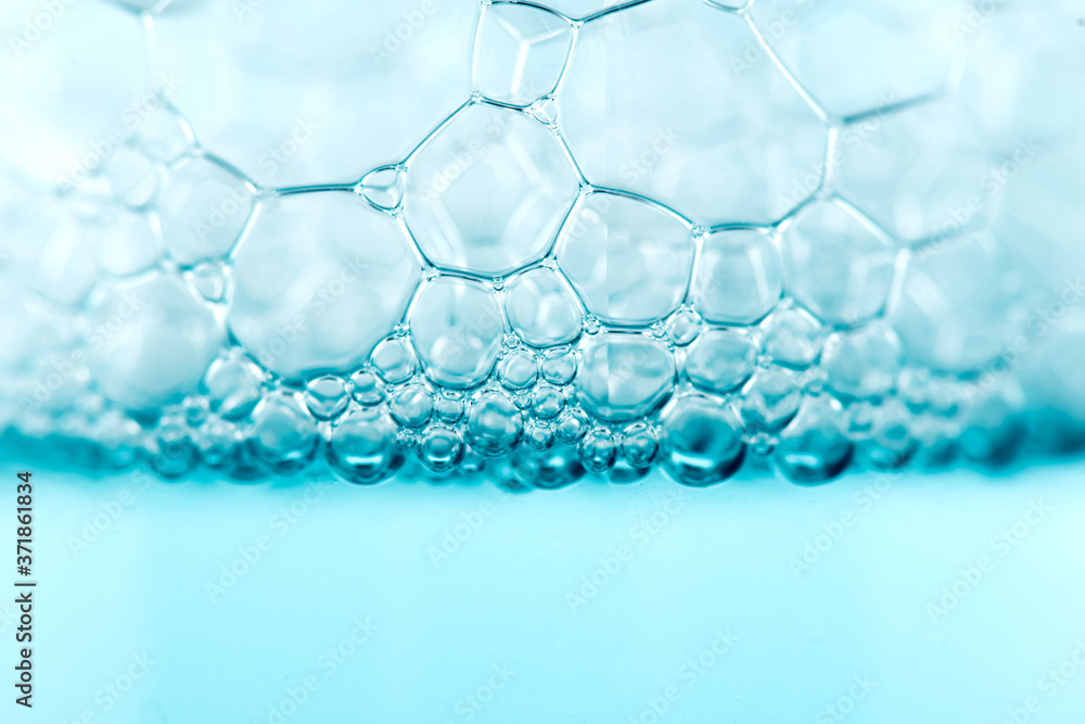 Foam. Soap foam popping bubbles background. Soap sud macro structure. Soap foam close-up, blue background. Foam. Soap foam popping bubbles background. Soap sud macro structure. Soap foam close-up, blue background.