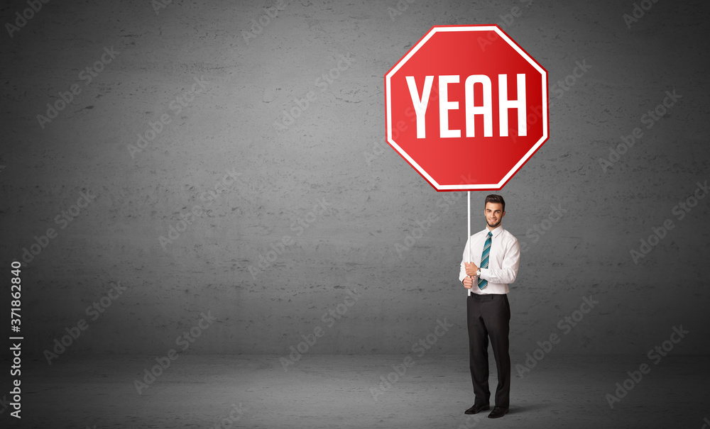 Fototapeta premium Young business person holding road sign with YEAH inscription, new rules concept