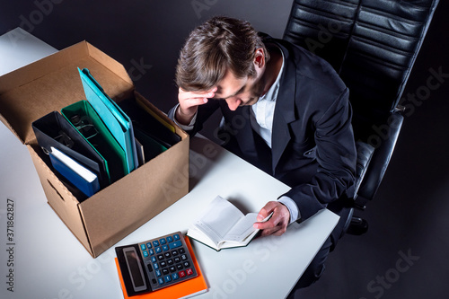 Unemployed man sits at tabl...