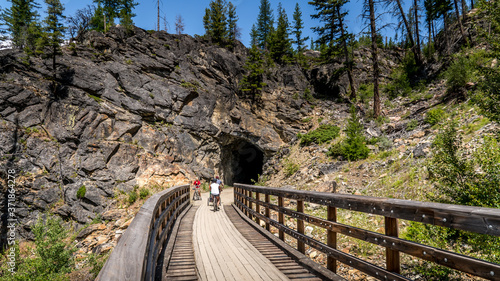 Biking over the Wooden Trestle Bridges of the abandoned Kettle Valley Railway in Myra Canyon near Kelowna, British Columbia, Canada photo