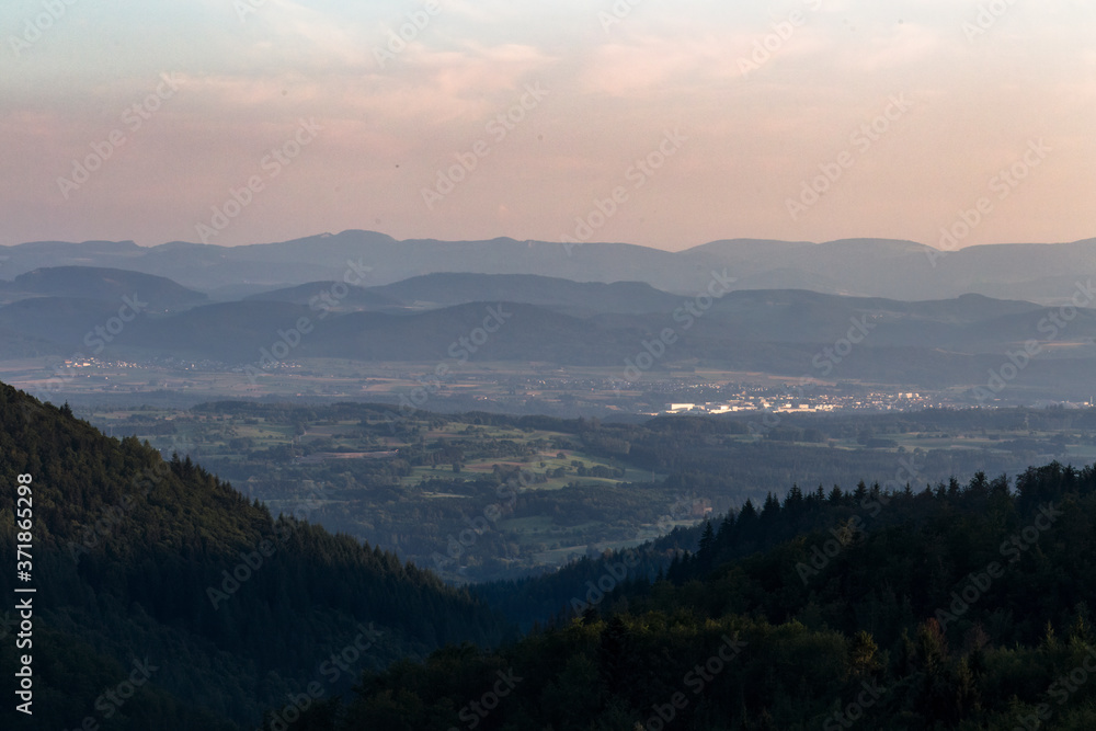 Panorama at sunset from the mountains of the Black Forest near Gersbach over the Wehratal and the city of Wehr towards the Swiss Alps