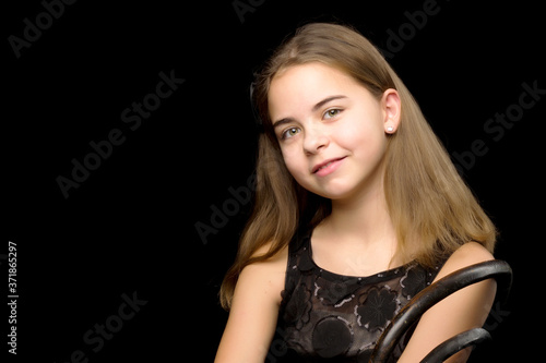 Close-up.Portrait of a cute little girl on a black background.