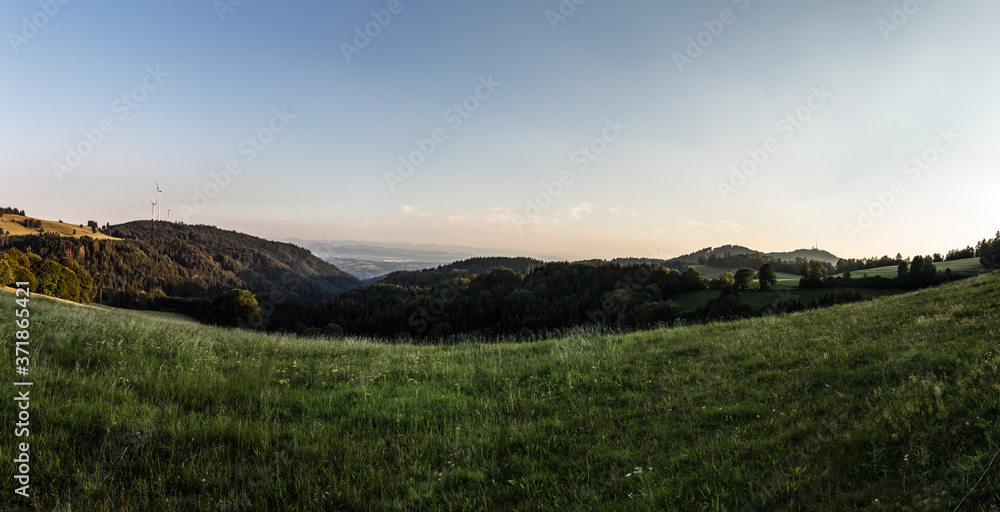 Panorama at sunset from the mountains of the Black Forest near Gersbach over the Wehratal and the city of Wehr towards the Swiss Alps