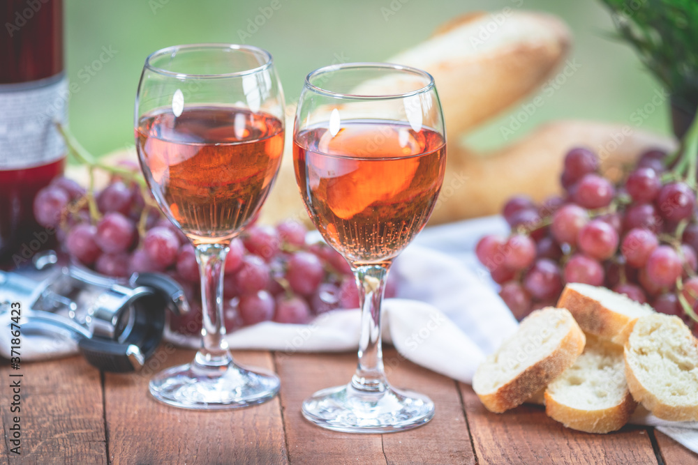 Wine, Grapes, and French Bread on a Picnic Table