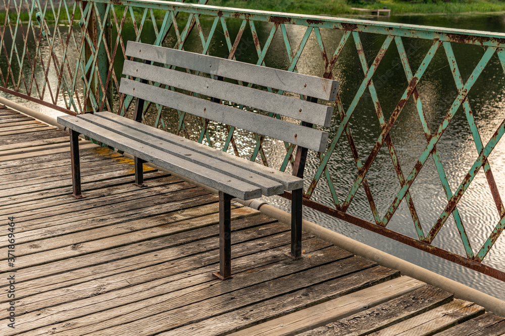 Fototapeta premium Bench on an historical bridge landscape