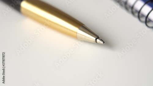 Wallpaper Mural Golden black pen and closed notepad on white office desk. Metal personal accessory for business and education Torontodigital.ca