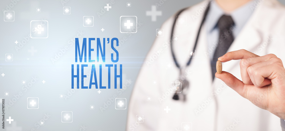 Close-up of a doctor giving a pill with MEN’S HEALTH inscription, medical concept Close-up of a doctor giving a pill with MEN’S HEALTH inscription, medical concept