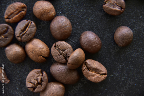 Coffee grains on dark background close up view