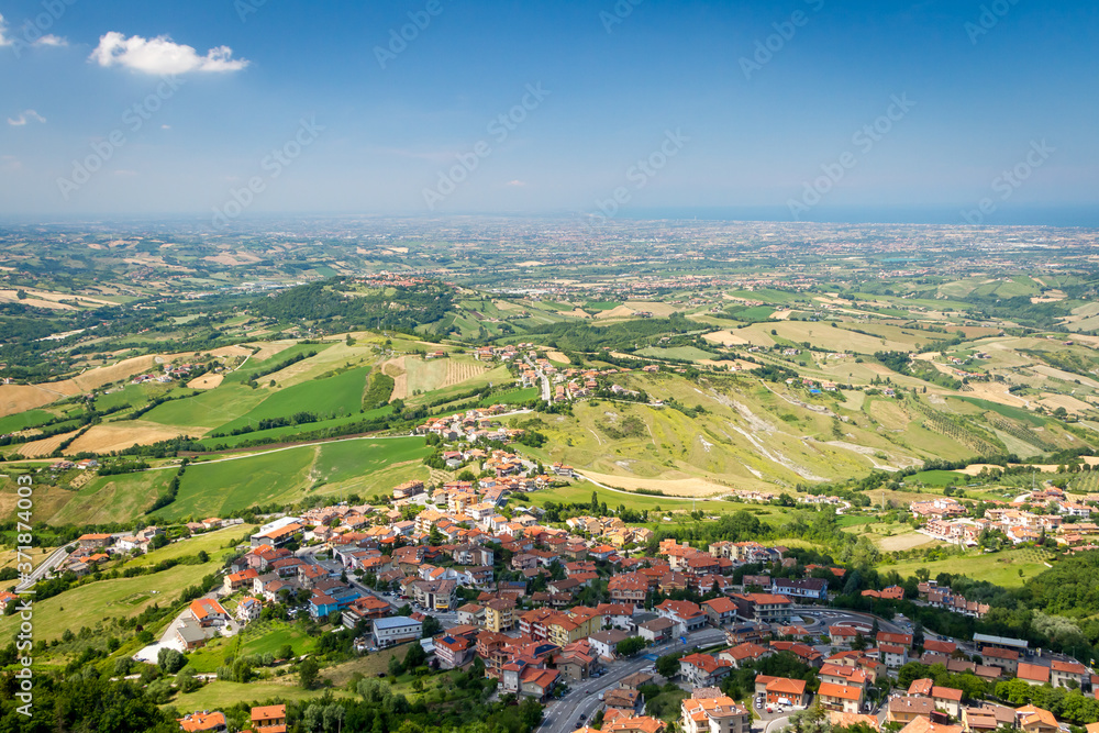 Panorama of Republic of San Marino and Italy from Monte Titano, City of San Marino. City of San Marino is capital city of Republic of San Marino located on Italian peninsula, near Adriatic Sea.