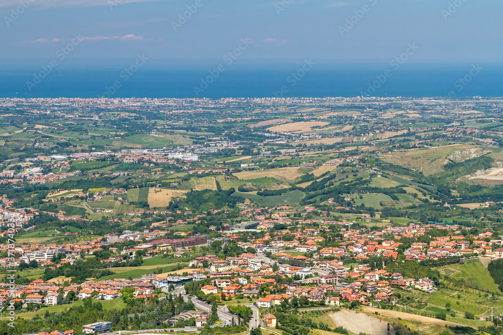 Panorama of Republic of San Marino and Italy from Monte Titano, City of San Marino. City of San Marino is capital city of Republic of San Marino located on Italian peninsula, near Adriatic Sea.