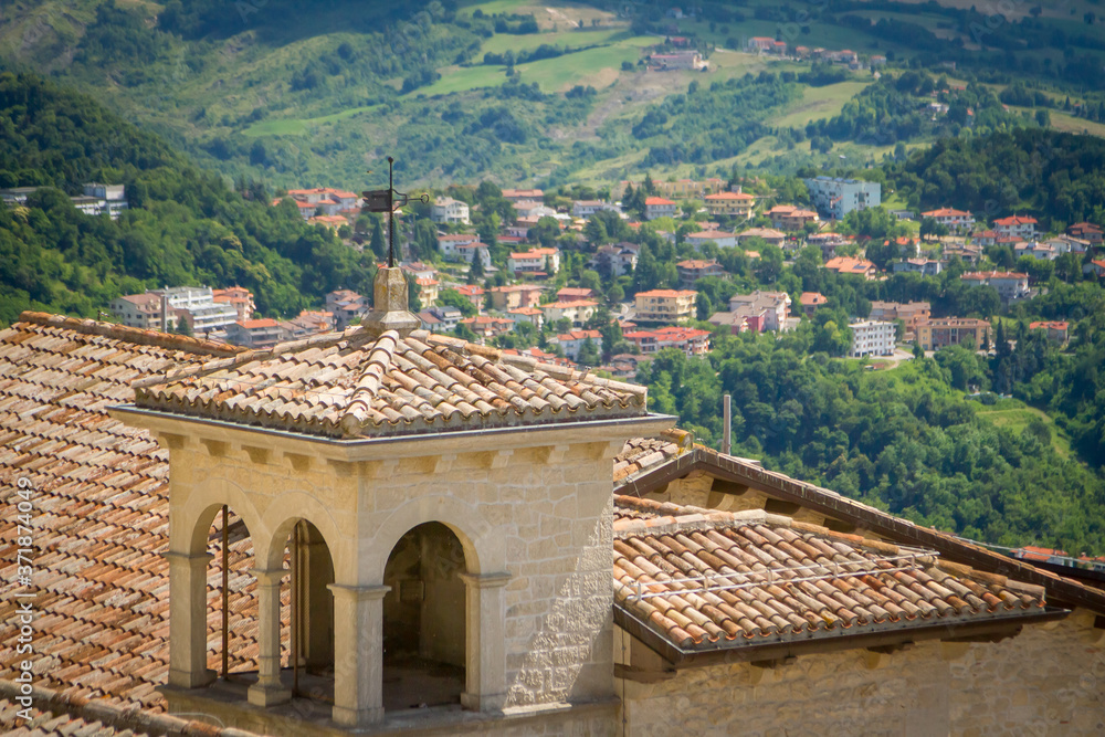 Old Ceramic Tile, roof. View of the surroundings of the Republic of San Marino. Chimneys and stormwater, lightning rods. mountains and fields in the background. Italy
