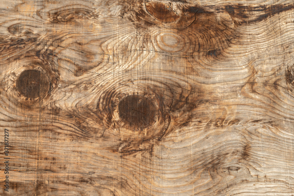 Naklejka premium Full-screen texture of a rough wooden slab with twigs and cracks