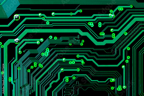Full-screen texture of green printed circuit board tracks on black with back light