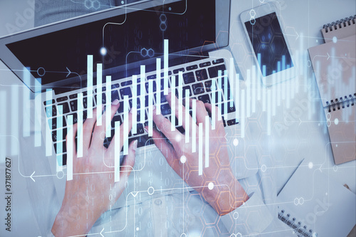 Double exposure of woman hands working on computer and forex chart hologram drawing. Top View. Financial analysis concept.