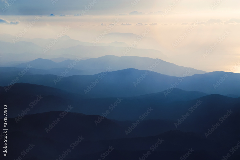 A chain of distant blue hills at dawn